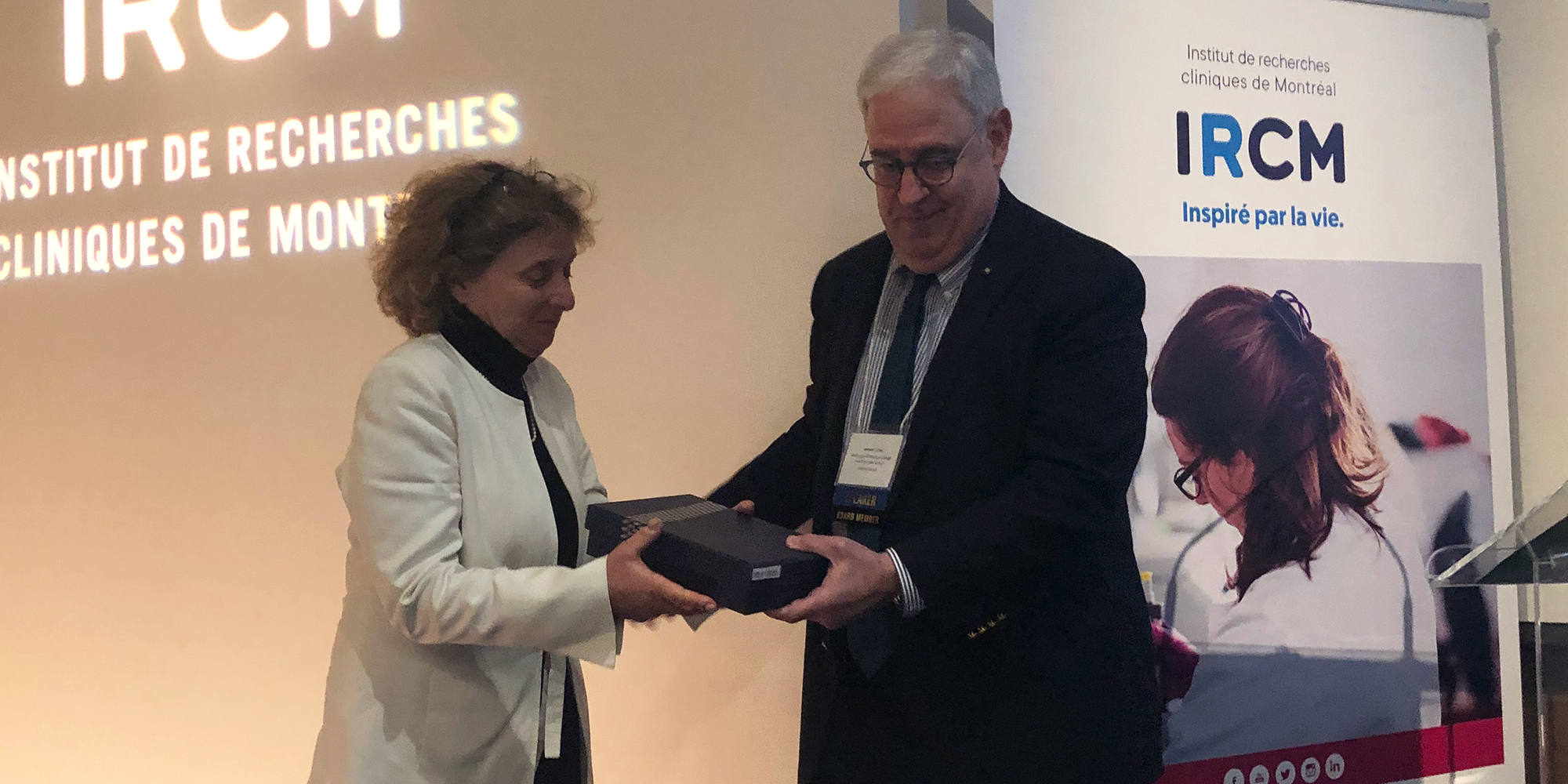 Judy Illes accepting a box with an award named after her, presented by Joseph J. Fins, INS President, at the 2022 INS Annual Meeting in Montreal, Canada;