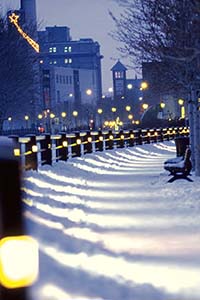 Lighted walkway with snow in the dim dusk light