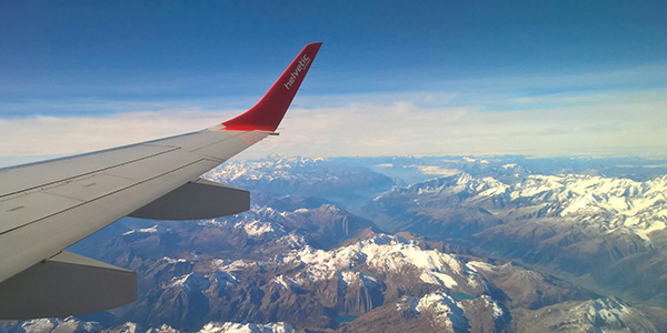 Air plane wing over snowy mountains. Credit: Andrea Vincenzo Abbondanza / via Unsplash